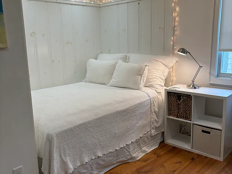 Small upstairs bedroom with a queen bed in nook and large closet