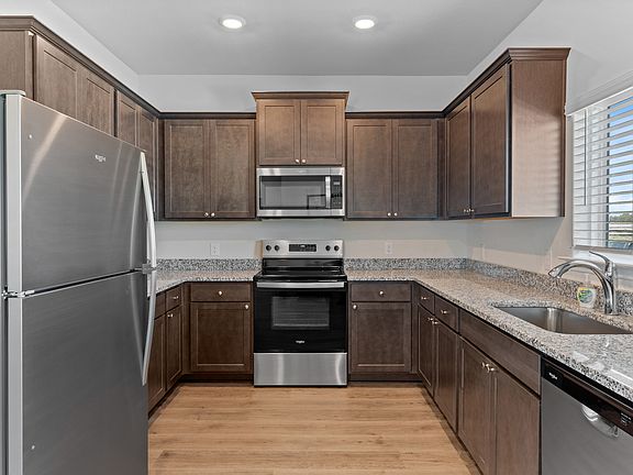 The kitchen has beautiful wood cabinetry.