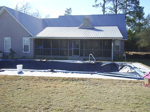 Back of house with in ground