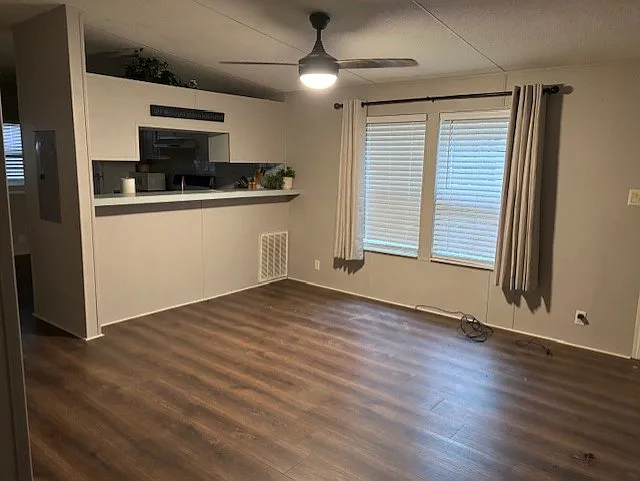 Living room: adjacent to Kitchen and separated by 1/2 wall. New Ceiling fan.