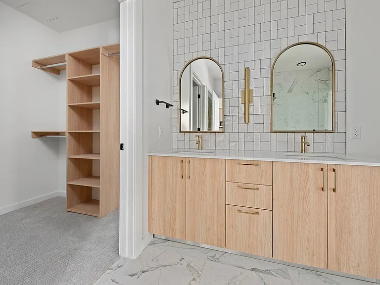 Bathroom with double vanities and upgraded custom closet at Moontower. Pictured here is the Sedona floorplan.