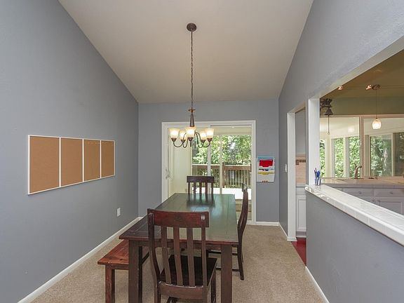 Formal dining area opens to the kitchen and deck for easy entertaining.