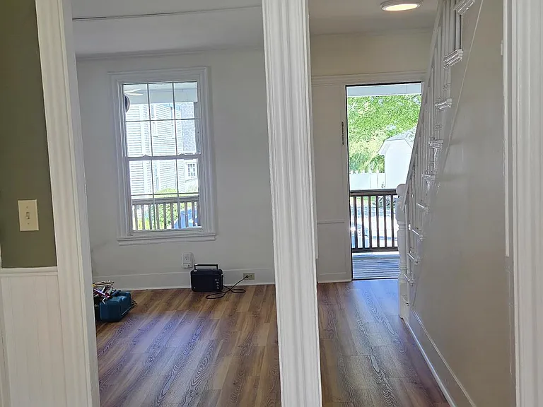 View From Dining Area Leading Into Living Area and Hallway Entrance To Unit