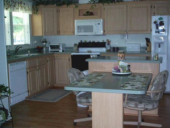 Kitchen w/wood flooring and corian countertops