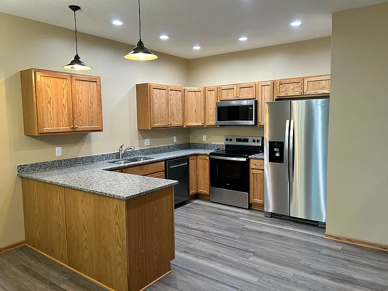 Open kitchen with granite tops (refrigerator not included)