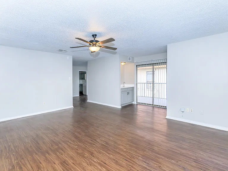 Townhome huge enormous living area with a wet bar, sliding door to your huge balcony, waiting to decorate with plants & patio furniture.
