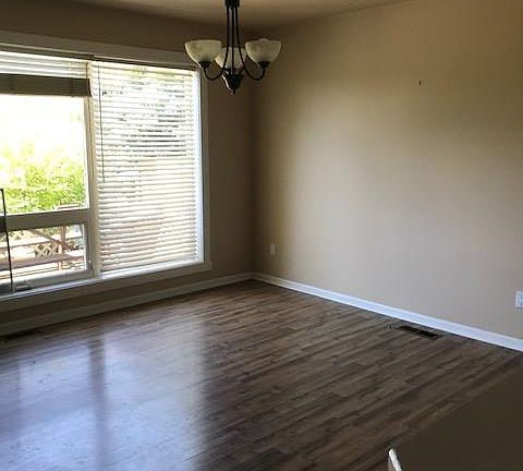 Dining area off of kitchen with laminate flooring