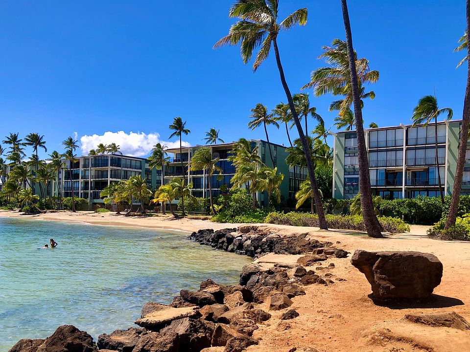 View of Kahala Beach Apartments from the beach. Ocean is calm and pristine fronting the property.
