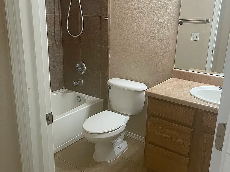 Guest bathroom with vanity, toilet and shower/tub combo