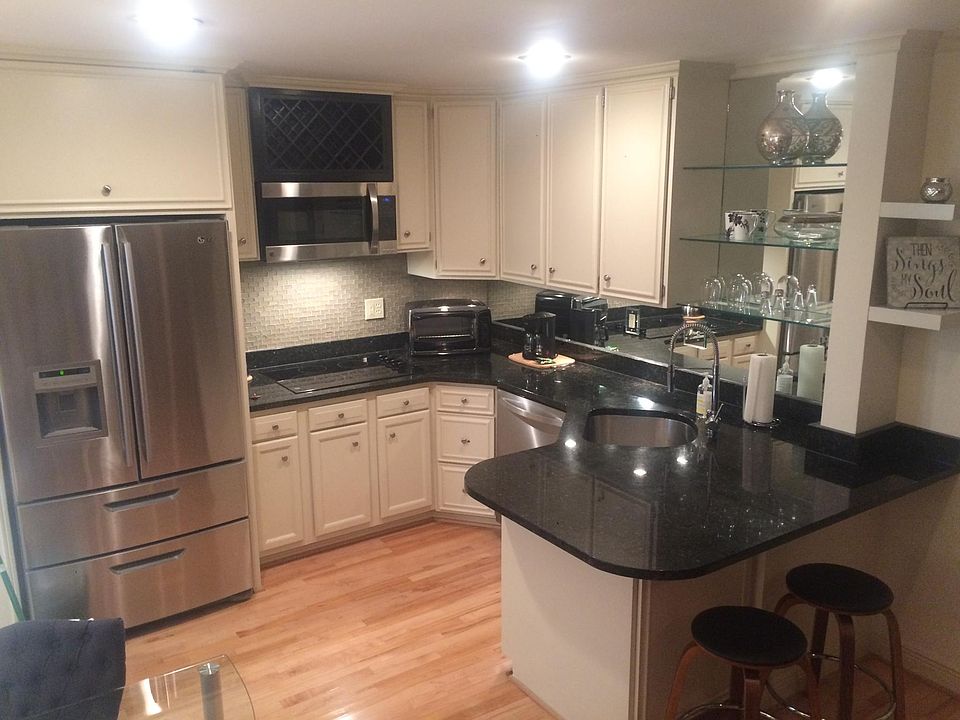 Glamorous mirrored backsplash. Granite countertops. Oversize