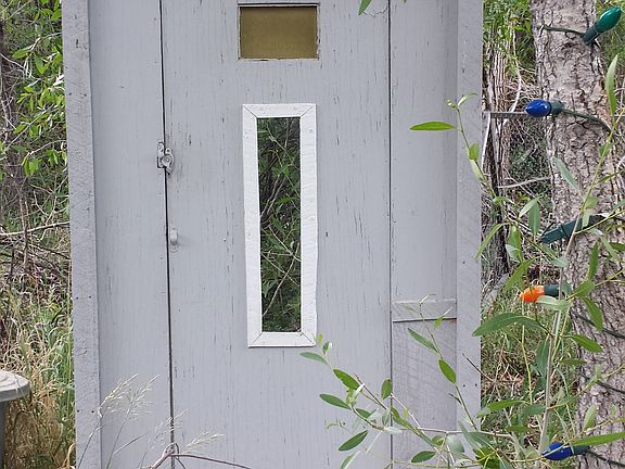 front of outhouse
