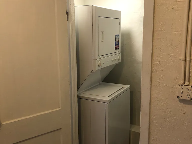 Entrance to the laundry room by the dinning room including a laundry center (dryer and washing machine)