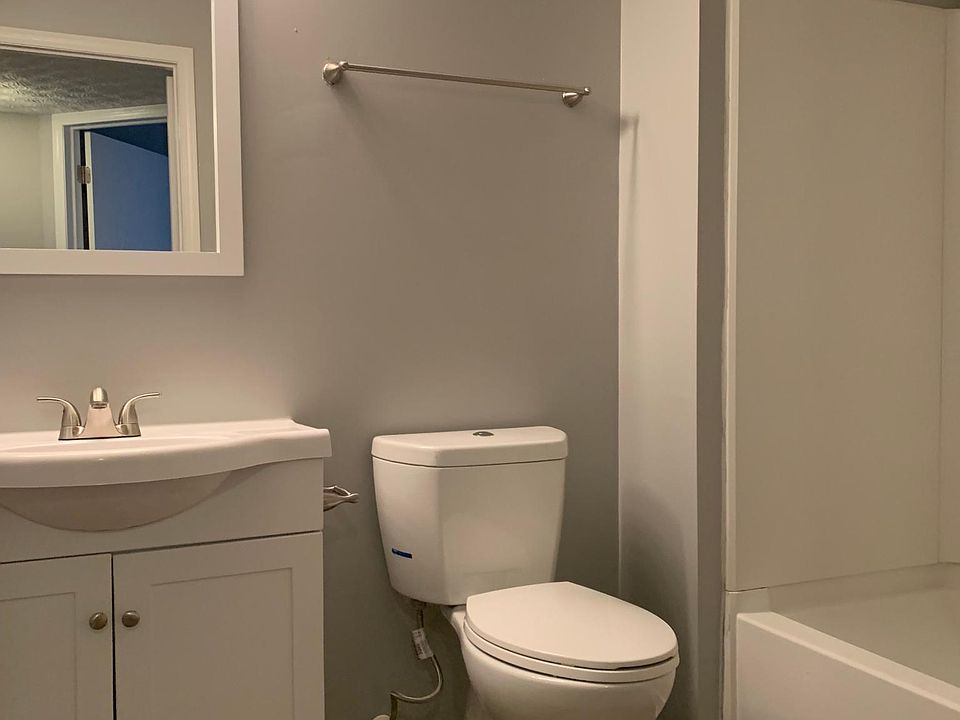 Hallway bathroom. Water efficient toilet with button on top