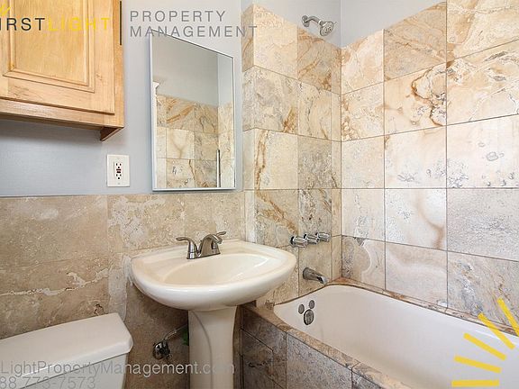 Tub, shower, window in bathroom