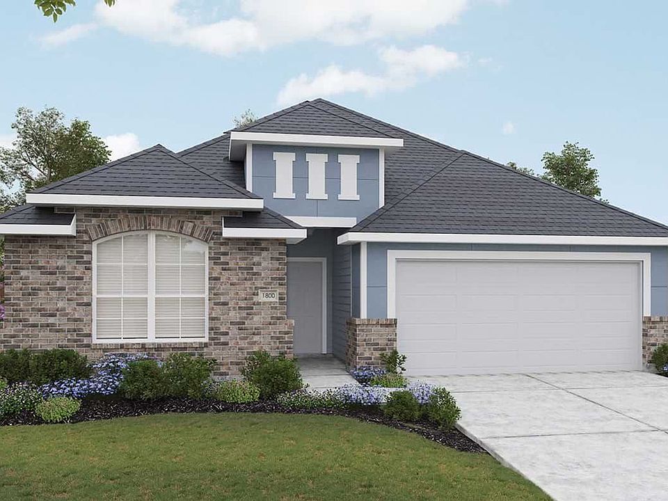 Elegant brick facade, arched windows, and pristine landscaping in Hunters Glen elevate this exquisit