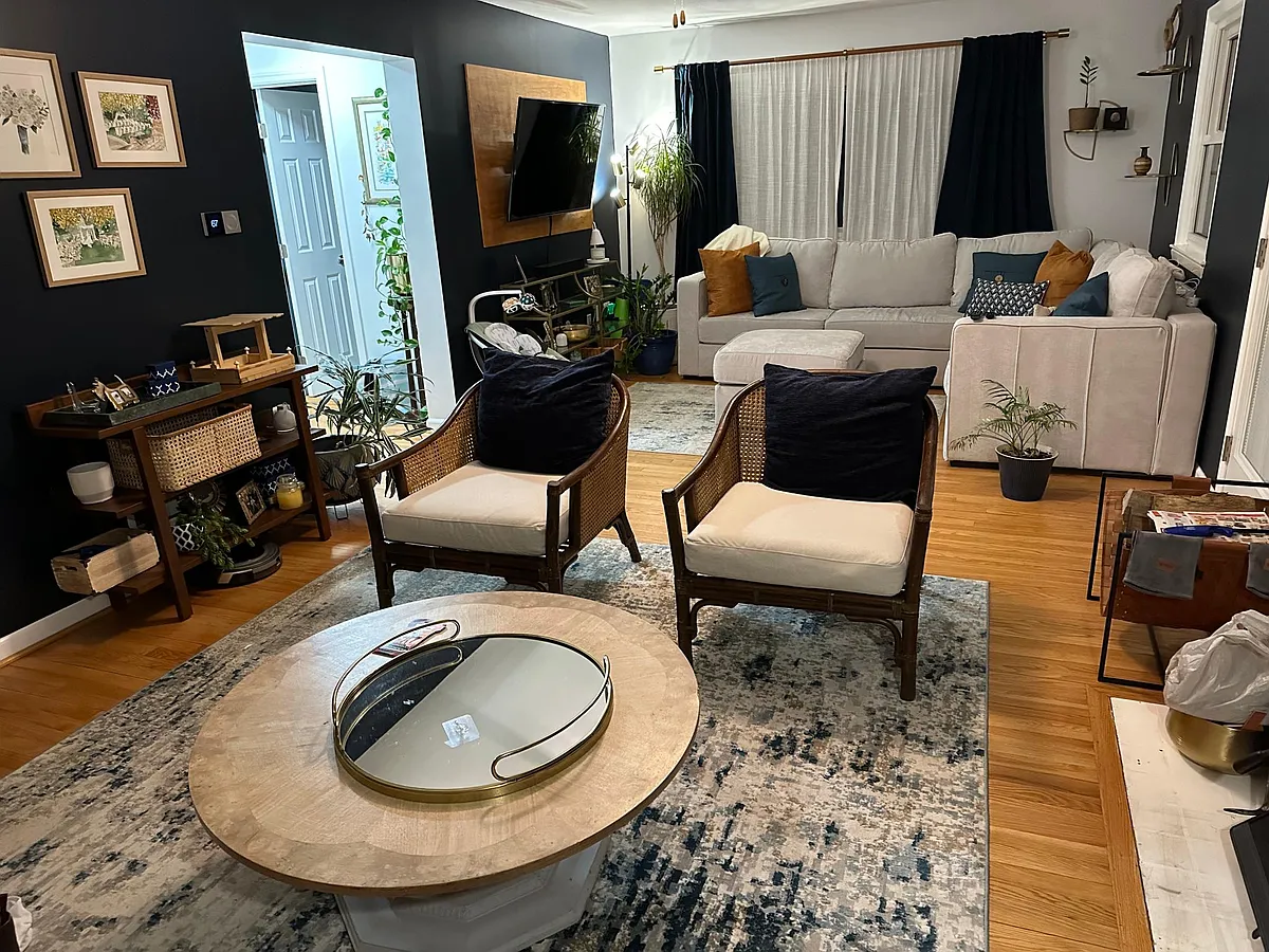 Living room. Large enough to fit two separate seating areas. Features a stove insert fireplace. 24.5' x 12.5' - 10422 44th Ave