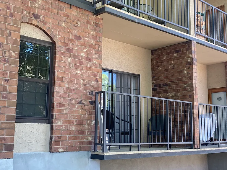 Balcony accessed through sliding doors in bedroom and glass door in living space