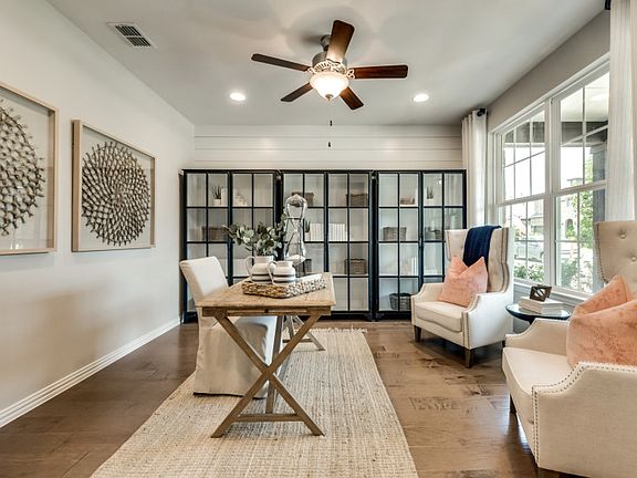 Flexible living space off entryway, shown as study