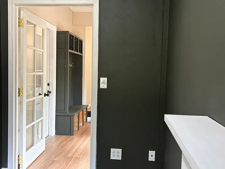 A transom window above the office door is a distinctive architectural detail that makes for a classy and inspiring workspace