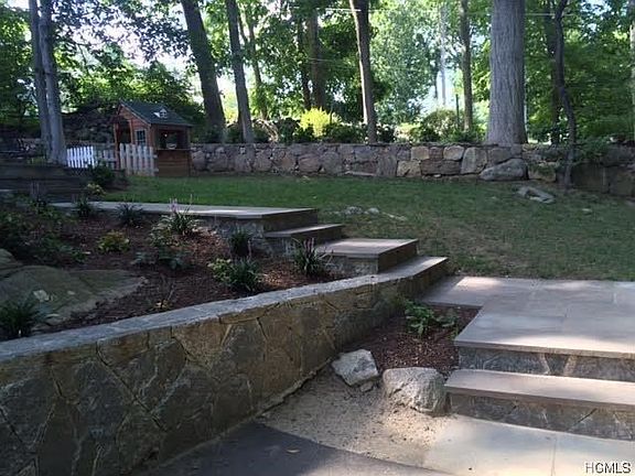 Hand cut stone retaining walls and stairs to the back