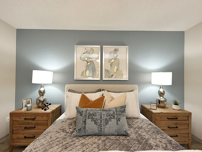 Cozy bedroom with hardwood-style flooring and ceiling fan