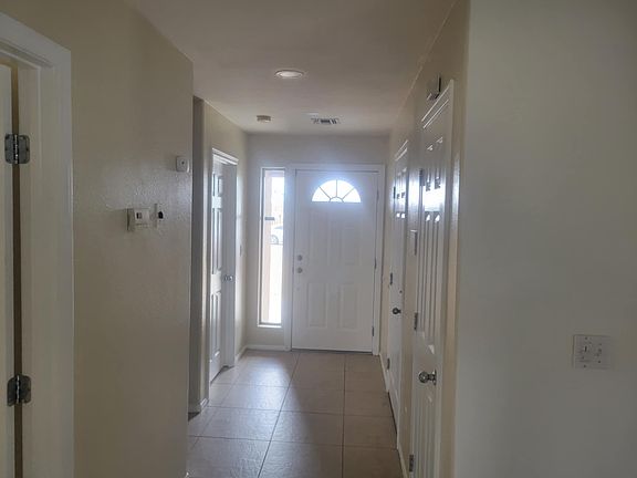 Entrance. Bedroom 3 is on the left next to the front door, and the garage entrance is on the right next to the front door.
