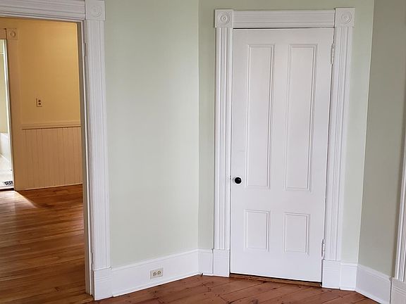 Living room leading to kitchen and bedroom, closet