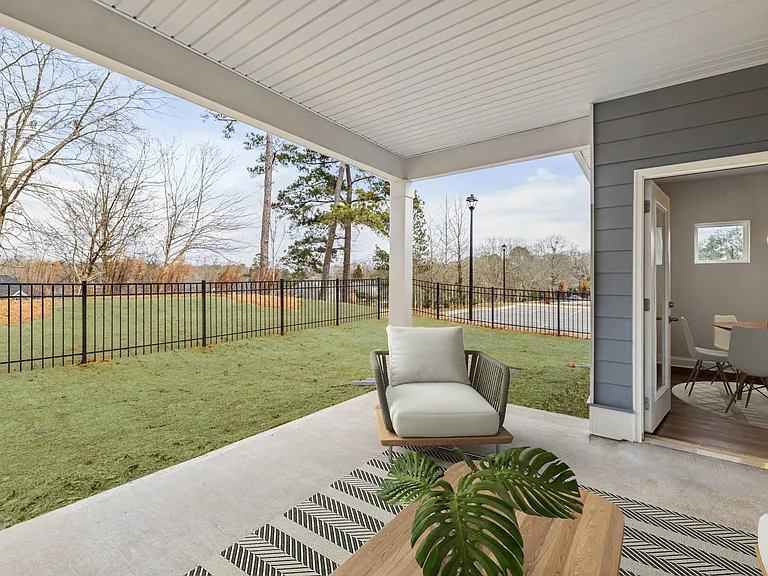 Covered back patio with fenced in yard.