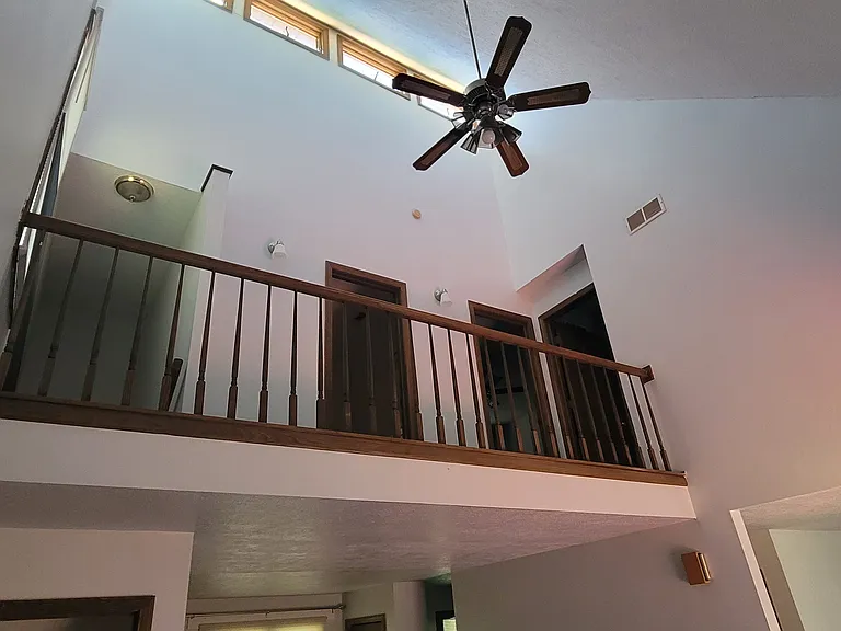 View from the living room showing the upper level bathroom and 2 bedrooms.