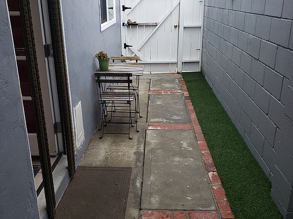Sideyard with entrance to unit