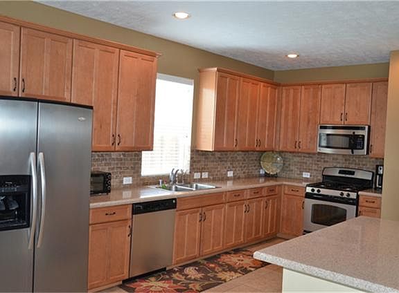 ...an entertainer's delight in this over-sized kitchen; notice the stainless appliances and cabinet hardware