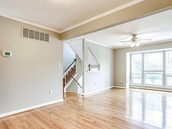 Dining room looking into the family room (family room fan has been replaced with a brand new light fixture). Note the hardwood floors - there is no carpet in the entire unit!