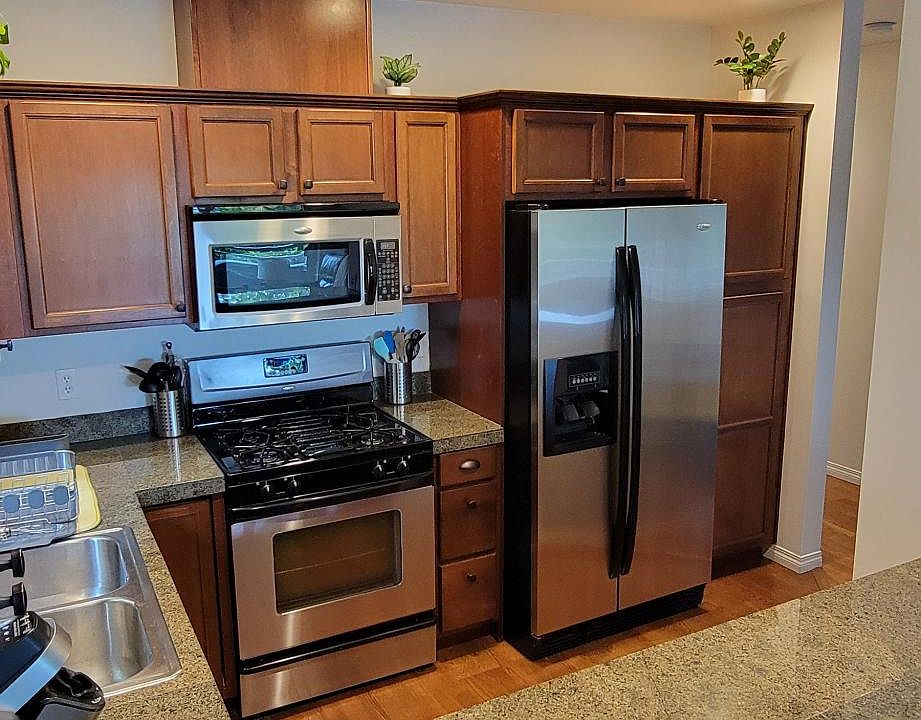 Stainless Kitchen Appliances with natural gas stove and oven. Spacesaver Microwave with vent. Large capacity refrigerator and plenty of cabinets for storage.
