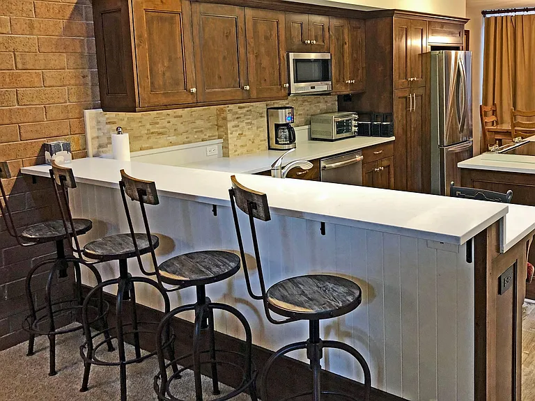 Besides seating for 6 at the dining table, there is also seating for four at the bar height counter overlooking the kitchen.