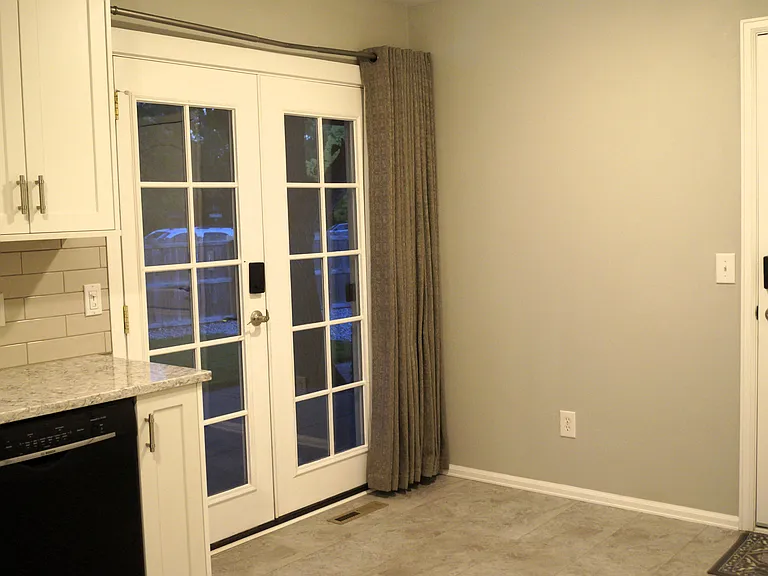 Double doors with thermal curtains to backyard patio.
