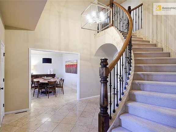 Modern Light Fixture and Access to Dining Room off the Entry.