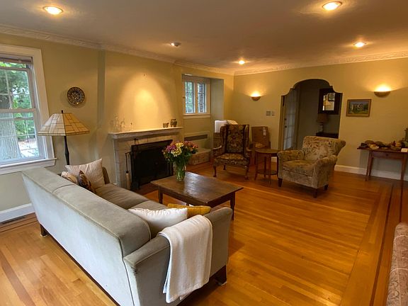 Spacious living room with wood burning fireplace and recessed lighting