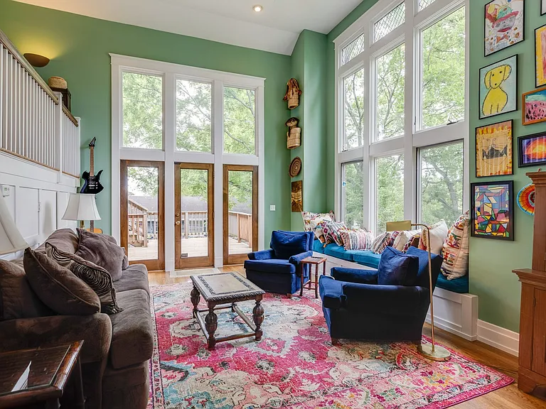 Family room/den with floor-to-ceiling windows. Over looking backyard and access to expansive 2 tier deck.