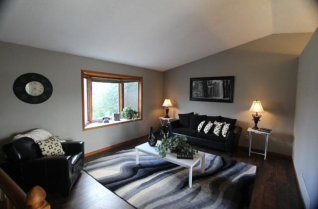 Living room with vaulted ceiling and beautiful laminate flooring.