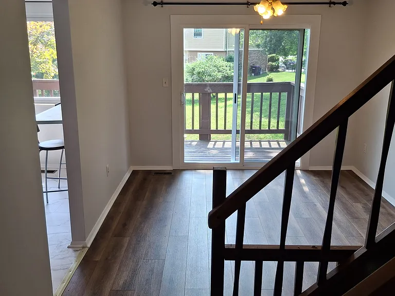 Dining Room with Ceiling Fan and access to Kitchen with Breakfast Bar.