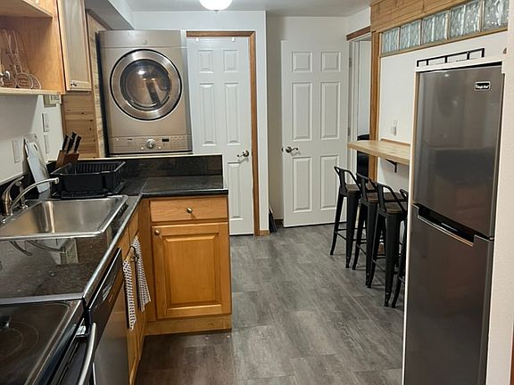 Kitchen with view to washer/dryer; bathroom and den/office