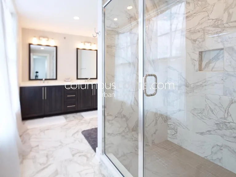 master bathroom has oversized custom walk-in shower and large double vanity