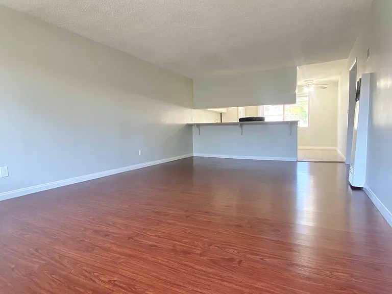 Generous living room space with view to the breakfast bar and kitchen