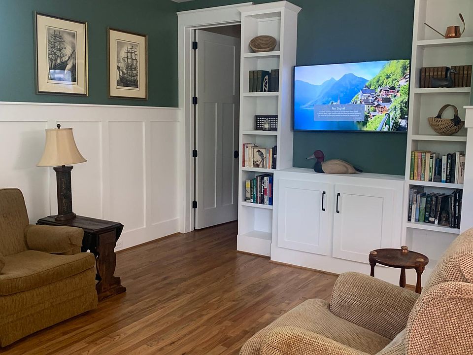 As you walk into the apartment, the living room is on your left with three recliners and a chair. The powder room is through door to the left of the bookcase.