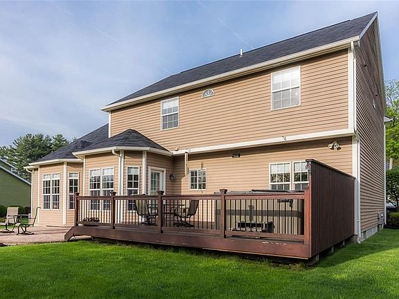 Deck with privacy screen leading to large stampcrete patio.