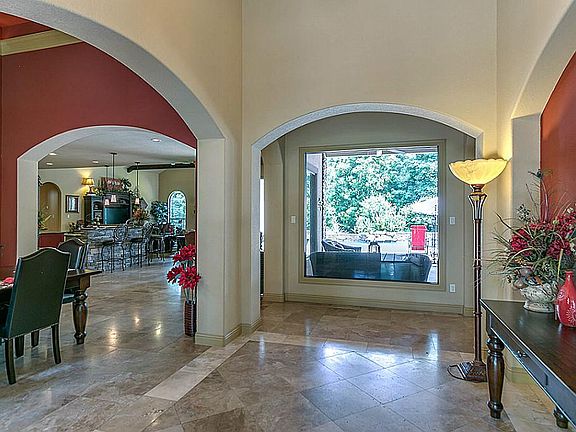 Upon first stepping into the home, you are greeted with spectacular views to the deep covered patio 