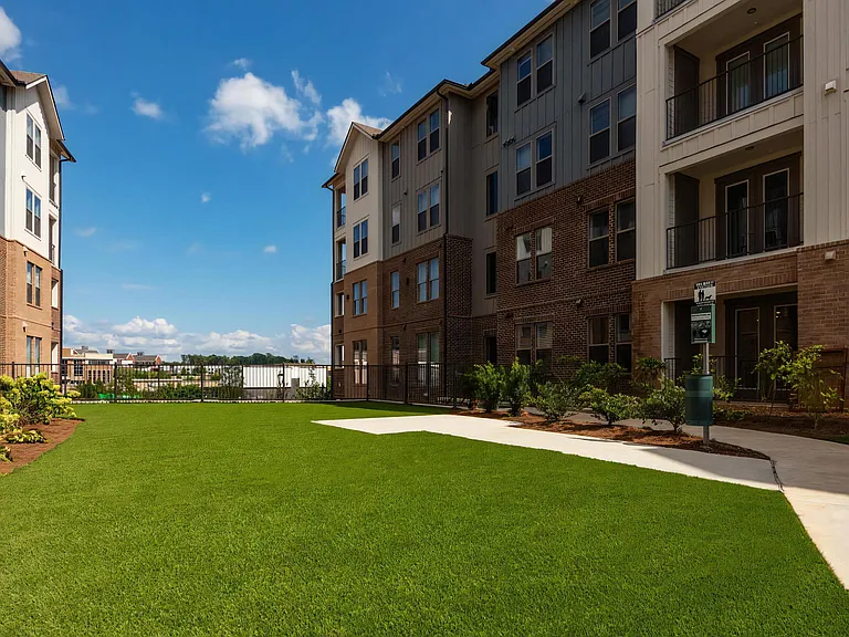 Pet-Friendly Grass Courtyard with Sidewalk and Dog Amenities