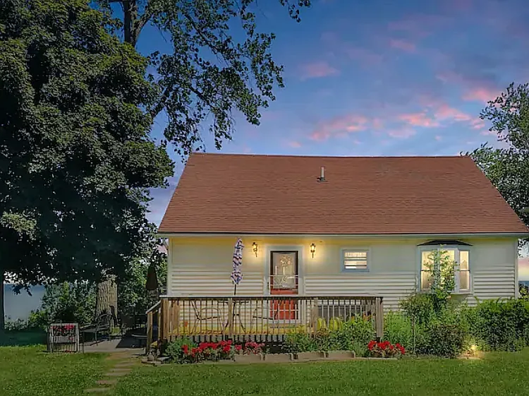 Darling cape cod style single family home right on Lake Ontario, beautiful yard with assorted perennials