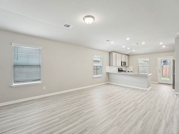 The open concept kitchen, living, and dining areas are great for entertaining.