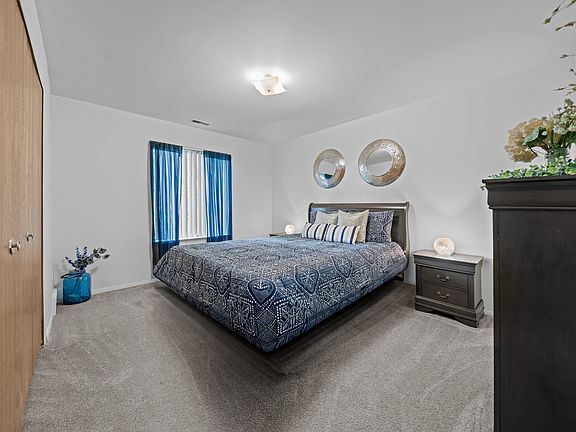 Cozy bedroom with natural light at Westwood Village Apartments in Westland, MI